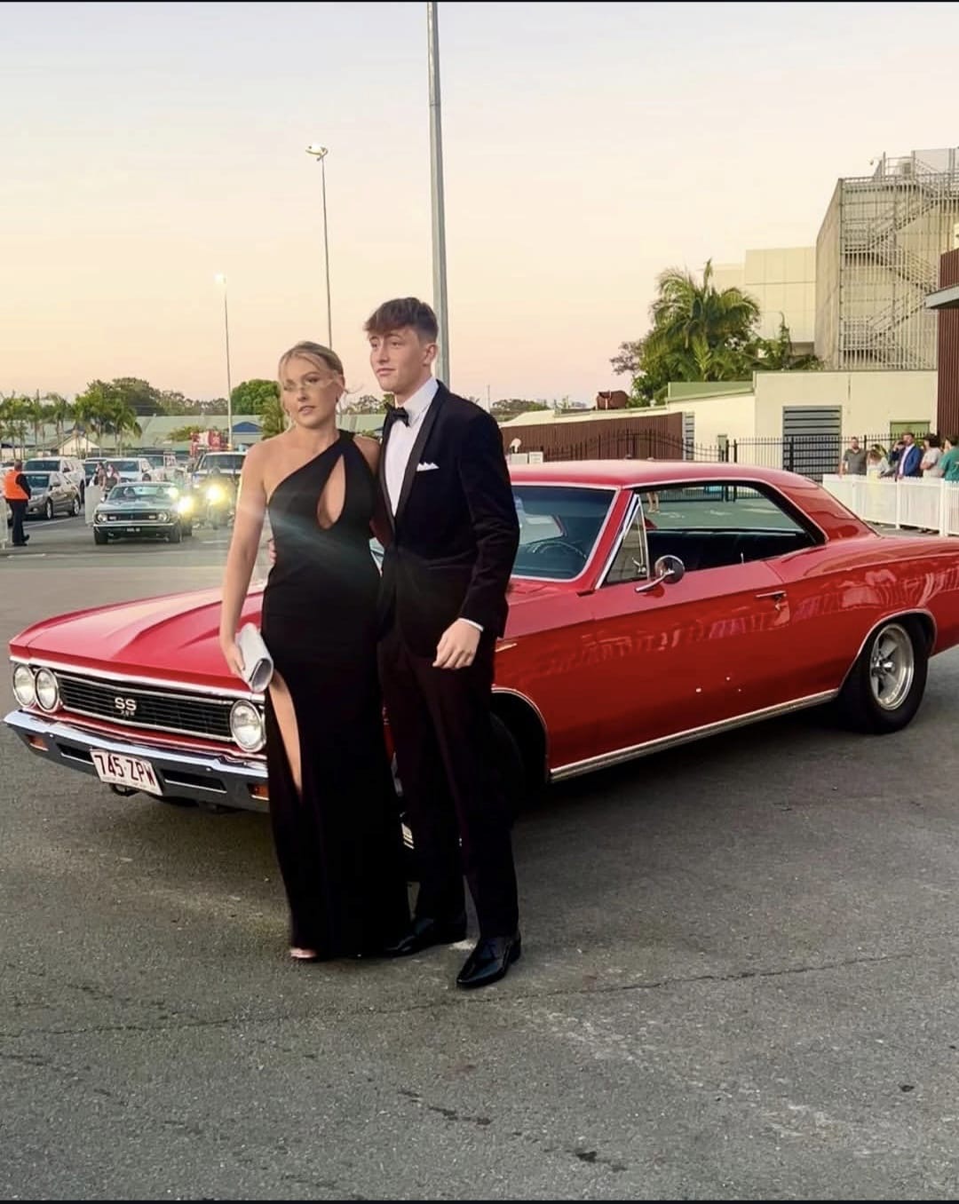Formal couple with the Chevelle at sunset